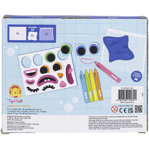 Back of a TIGER TRIBE "Bath Faces" craft kit box featuring colorful drawing materials including crayons, sticker sheets with eyes and mouths, a purple pouch, and instructions. Ideal for creative play with fun elements like Bath Faces and bath crayons. Blue grid background with product information and safety icons.