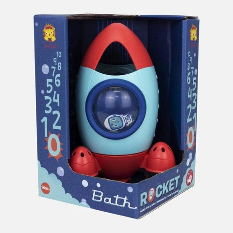 A vibrant Tiger Tribe Bath Rocket designed for interactive water explorations is displayed in its packaging. The rocket, predominantly red, blue, and teal with a circular window revealing a small toy figure inside, is packaged in blue with the label "Tiger Tribe Bath Rocket." Suitable for ages 18 months and up, it's perfect for sensory play.