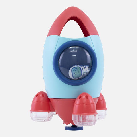 The Tiger Tribe Bath Rocket by TIGER TRIBE features rounded wings and a handle on top. This colorful bath toy boasts a light blue body with red accents, including a clear dome window at the center that showcases a smiling astronaut illustration. Perfect for sensory play and interactive water explorations, it stands on three transparent, circular legs.