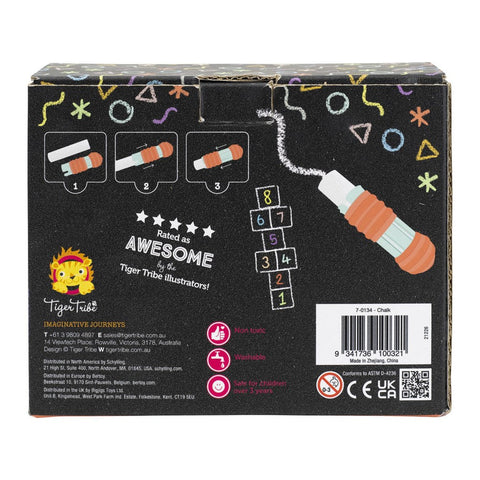 The back of the Tiger Tribe Chalk Stationery box showcases step-by-step instructions for using the easy-grip chalk holder, a vibrant rainbow starburst effect, and essential safety icons. It also proudly displays "Rated Awesome by TIGER TRIBE illustrators!" alongside a hopscotch drawing and highlights Jumbo-sized chalk perfect for outdoor play.