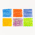 A white background highlights six vibrant squares, ideal for imaginative children. Each square features a distinct pattern: Top row includes blue with squiggles, red with yellow dashes, and dark blue with pink dots. The bottom row showcases orange with waves, purple with lime green spirals, and lime green with a cyan checkerboard design. This colorful set comes from the Tiger Tribe Colour Change Markers by TIGER TRIBE.