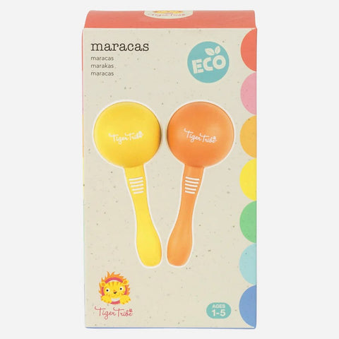 A colorful package labeled "Tiger Tribe Maracas" contains a pair of children's maracas made from sustainable bio plastic. One maraca is yellow and the other is orange. The packaging features the text "TIGER TRIBE" and colorful decorative accents. Recommended for ages 1-5, these eco-friendly maracas promise a fun musical adventure.