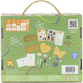 The back of the Tiger Tribe Nature Art Set, a green preschool craft kit box with a carrying handle, showcases items like yarn, markers, and various cutout shapes perfect for creative play for kids. A grid on the top left lists item quantities, and text on the right invites scanning a QR code for ideas. The set includes 10 meters of yarn.