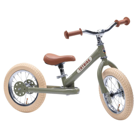 A TryBike - Vintage Green from TryBike, featuring a brown saddle and handlebar grips, beige tires, and a sturdy metal frame. This 2-in-1 tricycle balance bike is perfect for young children learning to ride and practice balance before moving on to pedaling.