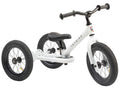 The TryBike - White by TryBike is a versatile 2-in-1 tricycle featuring a black seat and handlebar grips. The frame displays "TRYBIKE" in bold black letters. Equipped with large, durable rubber tires and a sturdy design, this Trybike Steel model is perfect for young children learning to ride and balance.