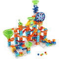 The VTech Marble Rush Adventure Set by Vtech includes 135 building pieces with vibrant green, orange, blue, and yellow tracks, loops, funnels, ramps, and wheels. Scattered marbles enhance the interactive play experience while an electronic Ferris wheel brings added excitement.