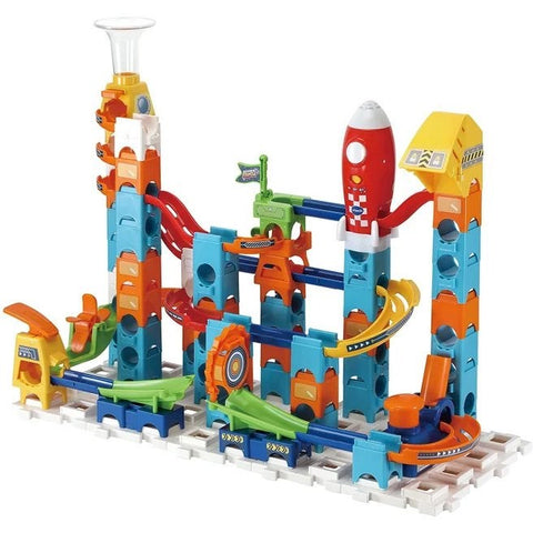 The VTech Marble Rush Launch Pad by VTech is a vibrant space-themed play set featuring a variety of interconnected tracks, ramps, tunnels, and playful elements such as a rocket and a spiral loop on a gridded base. Its bright blue, orange, red, and green pieces assemble into towers and pathways for marbles in this imaginative adventure.