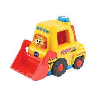 The Vtech Toot-Toot Drivers Bulldozer is a colorful toy with a smiling face on the front. Its body is primarily yellow with red and blue details, and it features a red scoop. The wheels are black with red centers. This engaging toy has lights, buttons, and "Bulldozer" written on the side, making it perfect for the learning zone.