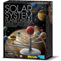 The image shows a boxed product labeled "4M Solar System Planetarium" by 4M. The front of the box depicts a completed solar system model with colorful planets on a stand. The planetarium kit also mentions that the planets can be painted and glow in the dark.