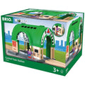 The image depicts a box of the Brio World Central Train Station toy by Brio, designed for children aged 3 and above. The packaging showcases an illustration of the wooden train station set, featuring a green arched roof, a platform, and a small figure. Eco-friendly markings are also visible on the box.