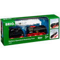 The image depicts the Brio World Steaming Train, a battery-operated toy set by Brio, in green packaging. The set includes a black and red locomotive, a water tender car, and is compatible with wooden train tracks from Brio World. Recommended for ages 3 and up, the packaging highlights its real steam feature with model number 33884 visible.