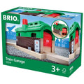 The image showcases a box of the Brio World Train Garage, featuring model number 33574. The front displays the green and red train shed, ideal for children aged 3 and up. An FSC logo confirms responsible sourcing of materials by Brio.