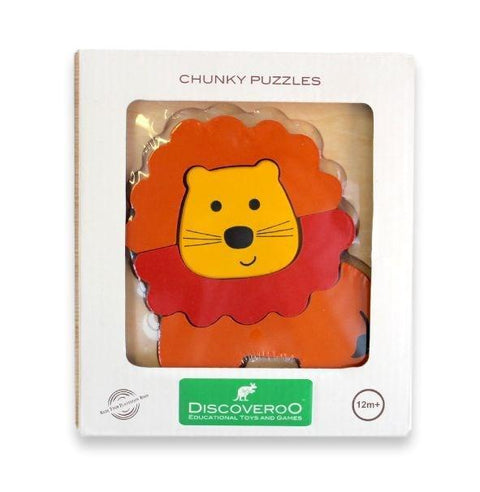 The image showcases the packaging of a Discoveroo Chunky Puzzle - Lion set. The box features a transparent window that displays the brightly colored wooden puzzle piece with a yellow face and an orange mane. This delightful animal-themed puzzle by Discoveroo is suitable for ages 12 months and up.