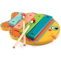 The Djeco Animambo Xylophone, a colorful fish-shaped toy musical instrument from DJECO, features five vibrant bars in blue, green, pink, and yellow. Two wooden mallets with red heads rest on top of the xylophone. The smiling fish boasts a vibrantly patterned body.