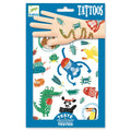 A blue package labeled "Djeco Tattoos - Animal Snouts" from the brand DJECO features colorful, cartoon designs of fun animals like a monkey, crocodile, panda, fish, toucan, and turtle. A hand on top displays some temporary tattoos applied to the skin. The "Dermatologically Tested" tag is visible at the bottom.