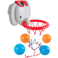 The HAPE Bath Time Basketball Elephant Pal by HAPE is a playful toy elephant head wearing red sunglasses, doubling as a basketball hoop with a red rim and white net. It can be conveniently mounted on a wall using the suction cups on the back. Ideal for bath or shower fun, it comes with four balls—two blue and two orange—that can be placed below the hoop.