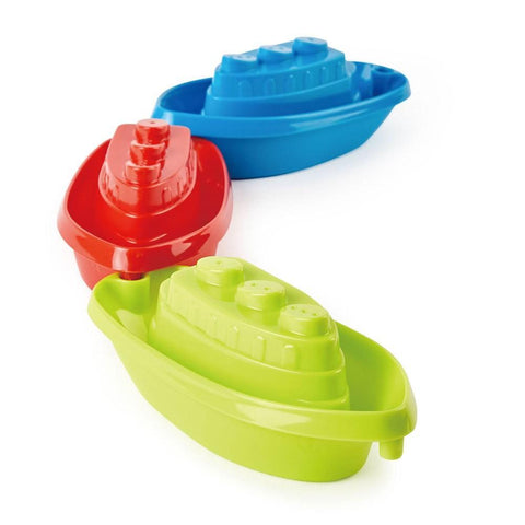 Three vibrant HAPE Beach & Bath Boats stacked together, perfect for beach and bath play. These plastic boats are bright, with the top boat being blue, the middle one red, and the bottom one green. Each boat's simple design includes small details like chimneys on top, ideal for little hands to grasp.