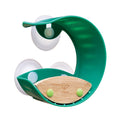 The HAPE Bird Feeder is a green, semi-circular toy with two suction cups for window attachment and a wooden base. It appears to be designed as a fun, engaging toy for kids, possibly as a bath accessory, and features the HAPE logo on the wooden part.