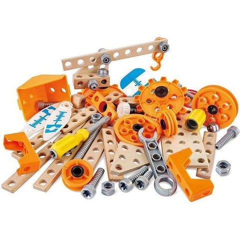 A collection of various construction toy parts, including orange and yellow gears, wooden beams with holes, screws, nuts, and other mechanical components, scattered on a white surface. This HAPE Deluxe Experiment Kit from HAPE is compatible with Junior Inventor sets for endless creative possibilities.