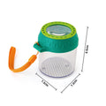 The HAPE Explorers Bug Jar by HAPE features a magnifying glass lid, an orange wrist strap, and a green top. This transparent cylindrical container includes a grid pattern at the bottom for measurement. Made from sustainable plastic, it has dimensions of 7.2 cm in diameter and 8.5 cm in height.