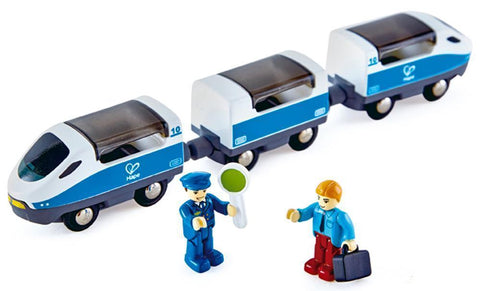 A toy train, known as the Hape Intercity Train, features a locomotive and two passenger cars. Accompanying it are two toy figures: one dressed as a conductor with a sign, and the other in civilian attire carrying a briefcase. The Hape Intercity Train from Hape provides endless opportunities for imaginative play for children.