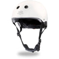 The Kinderboard Toddler Helmet - White Matte, designed for child safety during activities like biking or skateboarding, features a white exterior with ventilation holes on top and an adjustable black chin strap. The front of the helmet displays the "Kinderfeets" brand and includes an adjustable fit dial system for a secure fit.