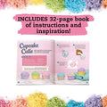 An open book displaying "Klutz Make Your Own Bath Bombs Scented Bakery" instructions with text and images illustrating a bath bomb-making process. The background features colorful, powdery textures, resembling a sprinkle of baking soda. The top text reads "INCLUDES 32-page book of instructions and inspiration!".
