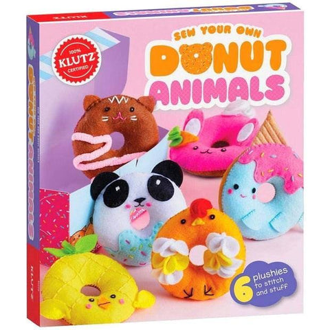 The Klutz Sew Your Own Donut Animals craft kit, brought to you by KLUTZ, features a vibrant box showcasing five adorable felt donut animals, including a panda, cat, and unicorn. Inside the sewing kit are all the supplies needed to create 6 plushies, proudly marked with a red seal labeled "100% Klutz Certified.