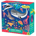 Bright box for the "Mudpuppy 25pc Jumbo puzzle - Depths of the Sea" by Mudpuppy. Showcases various sea creatures like a whale, dolphin, seal, turtle, and squid. Includes 25 pieces to enhance hand-eye coordination and features a handle with underwater illustrations on the box.