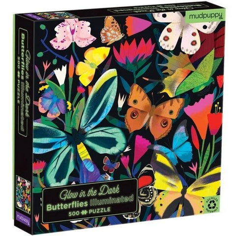 A vibrant jigsaw puzzle box titled "Mudpuppy 500pc Illuminated Glow in the Dark puzzle - Butterflies" showcases colorful illustrations of various butterflies among flowers on the cover. This 500-piece puzzle by Mudpuppy is ideal for a family activity and emphasizes its eco-friendly design.