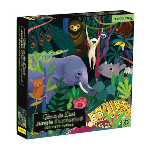 The image displays the box for the "Mudpuppy Glow in the Dark 500pc Puzzle - Jungle" by Mud Puppy. This 500-piece puzzle showcases vibrant illustrations of jungle animals such as an elephant, monkeys, a sloth, and a toucan against a dark jungle background that glows in the dark.