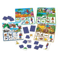 The Orchard Toys "Where Do I Live?" by Orchard Toys features an image of four colorful animal-themed bingo boards. Each board represents different animal habitats: ocean, jungle, Arctic, and desert. Surrounding the boards are several blue bingo cards and matching small animal images that players can place on the boards, creating an educational game about Animals of the World.