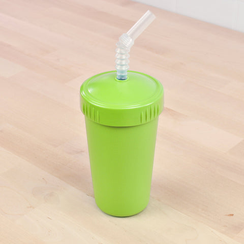 The Re-Play Straw Cup from REPLAY, featuring a vibrant green hue and matching lid, rests on a light wooden surface. The lid includes a clear, vertically ribbed, flexible straw crafted from recycled materials. This sustainable and stylish cup appears unused and pristine.