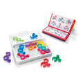 A logic puzzle game set is displayed, showcasing vibrant, translucent plastic pieces arranged on a white grid-based tray. Beside it lies an open booklet that features various puzzle configurations and solutions. Additional pieces are scattered around the tray, making this Smart Games IQ Link by Smart Games an ideal travel companion.