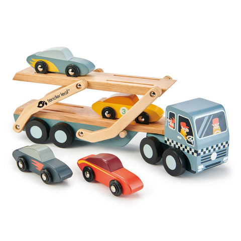 The Tender Leaf Car Transporter is a wooden truck with a detachable flatbed trailer, carrying four colorful super cars. The trailer features a natural wood finish and is painted in a gray and white checkered pattern. Proudly branded as "Tender Leaf Car Transporter," this toy showcases the quality craftsmanship of Tender Leaf.